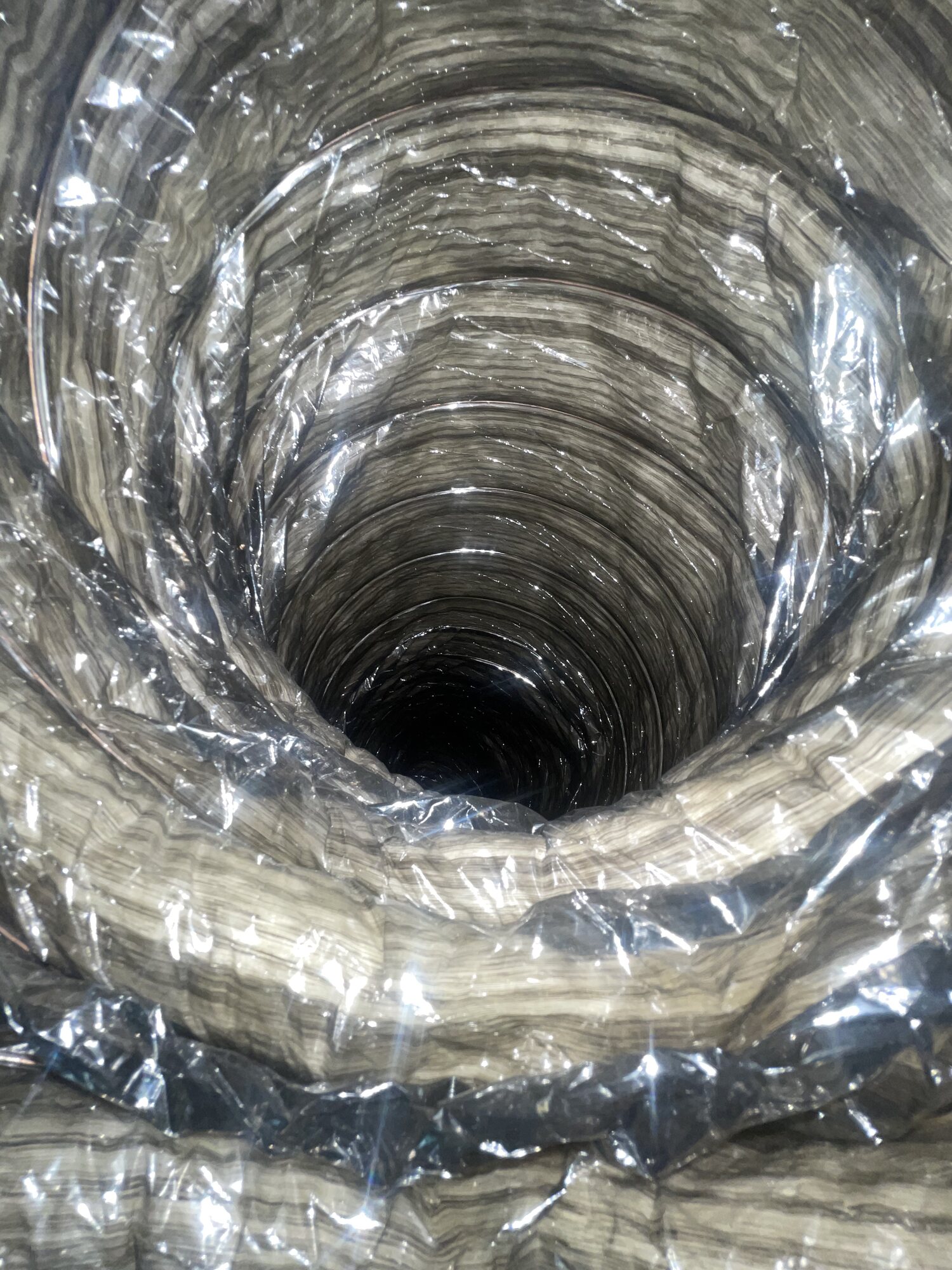 Interior view of a clean flexible air duct showing the ribbed duct wall